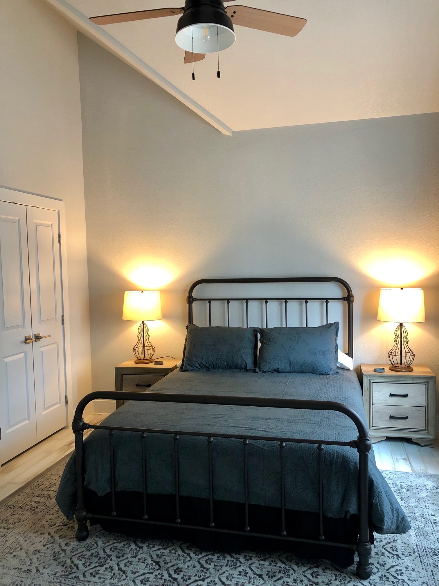 Bedroom with metal bed frame inside Summermoon Cottage