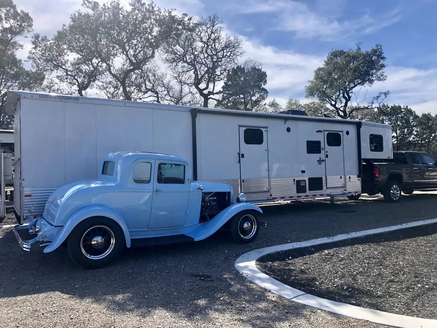 RV park area with paved roads and shade trees at Wayside Wimberley